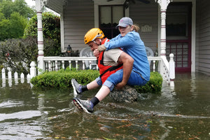 A Texas National Guardsman carries a resident from her flooded home following Hurricane Harvey in Houston, Aug. 27, 2017. Army National Guard photo by Lt. Zachary West